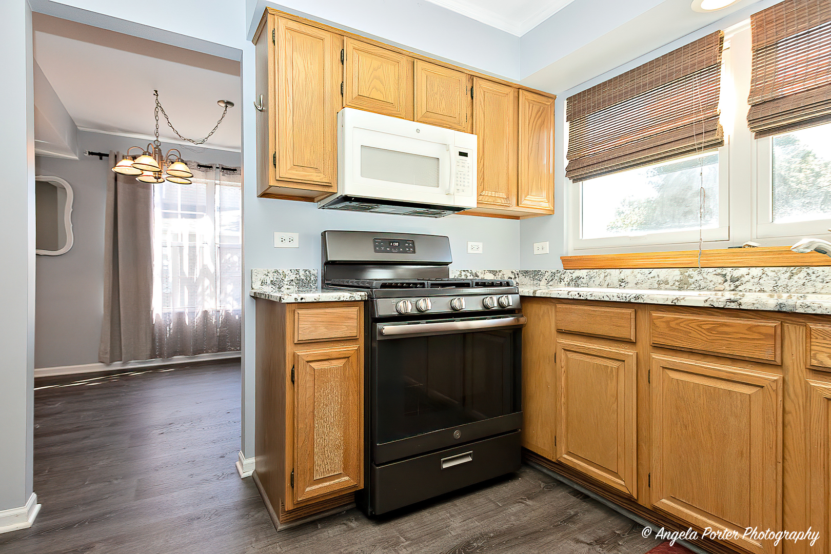 337 Claire Lane Cary, IL 60013 - Photo 5 of 35 a kitchen with granite countertop wooden cabinets and a stove