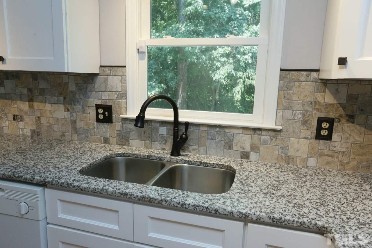 4921 Watkins Road Wendell, NC 27591 - Photo 3 of 25 Granite counter tops and tile back splash