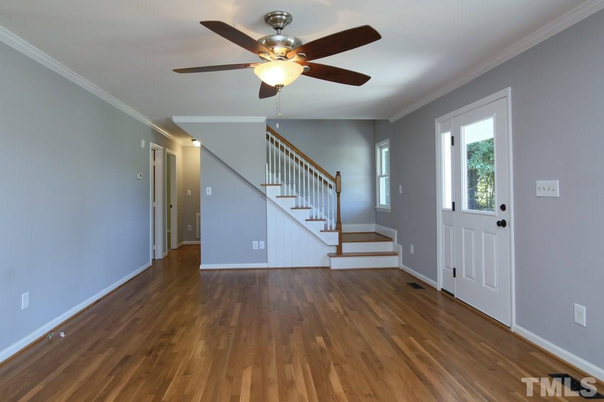 4921 Watkins Road Wendell, NC 27591 - Photo 8 of 25 Spacious living room with wood floors and ceiling fan.