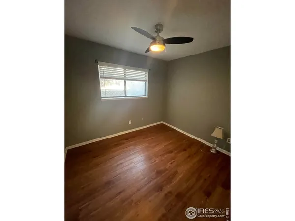 a view of a kitchen with wooden floor and a kitchen