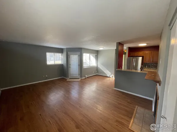 a view of a kitchen with wooden floor and a kitchen