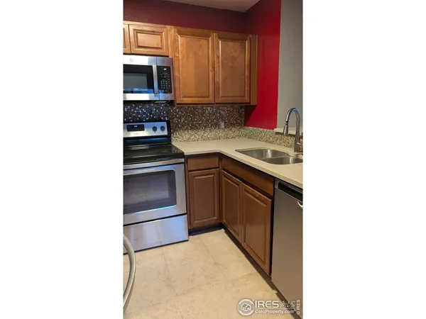 a kitchen with stainless steel appliances granite countertop a stove and a microwave