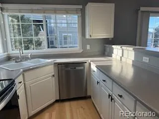 a kitchen with a sink stove and cabinets