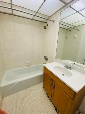 a bathroom with a sink a mirror and a bathtub