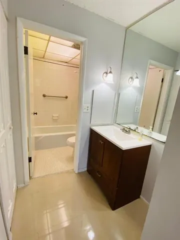 a bathroom with a sink vanity and mirror