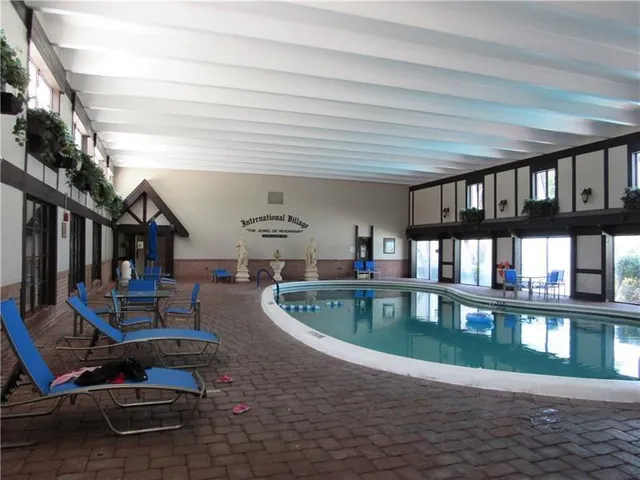 a view of a house with swimming pool and sitting area
