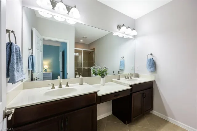 a bathroom with a double vanity sink and a mirror