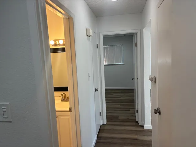 a view of a hallway with wooden door