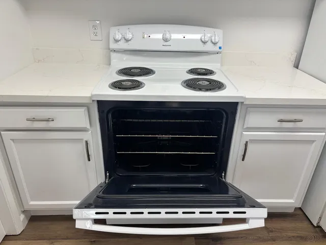 a stove top oven sitting inside of a kitchen
