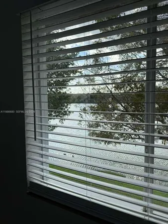 a view of a room with wooden floor and a bathroom