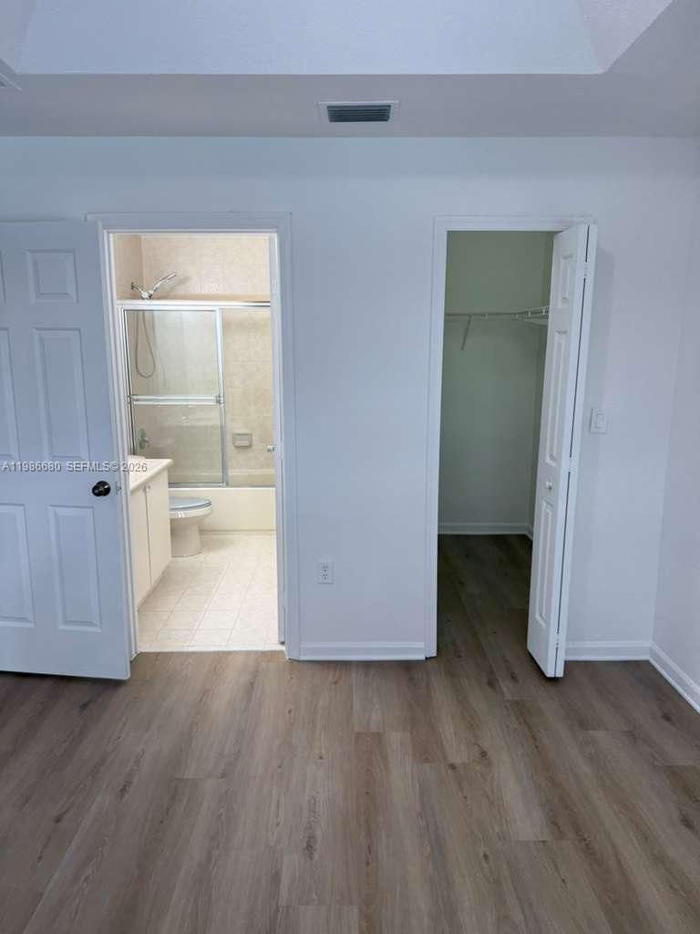 2470 Southeast 15th Place, Unit 335 Homestead, FL 33035 - Photo 16 of 33 a view of a room with wooden floor and a bathroom