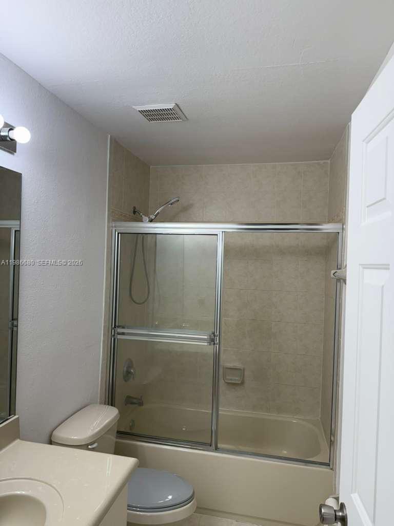 2470 Southeast 15th Place, Unit 335 Homestead, FL 33035 - Photo 18 of 33 a bathroom with a shower and a toilet