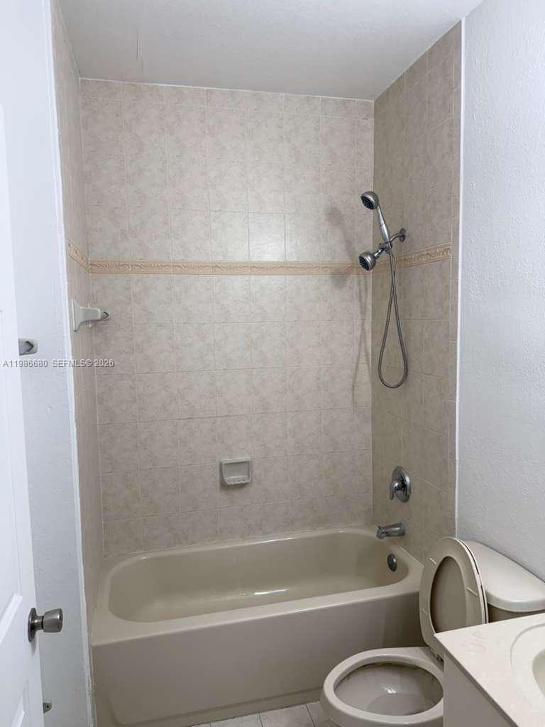 2470 Southeast 15th Place, Unit 335 Homestead, FL 33035 - Photo 20 of 33 a bathroom with a tub a toilet and a sink