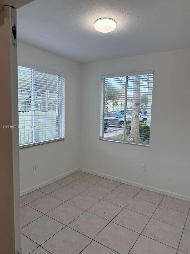 2470 Southeast 15th Place, Unit 335 Homestead, FL 33035 - Photo 21 of 33 an empty room with windows