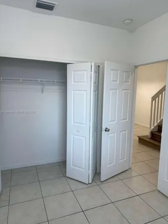 a view of an empty room and entryway