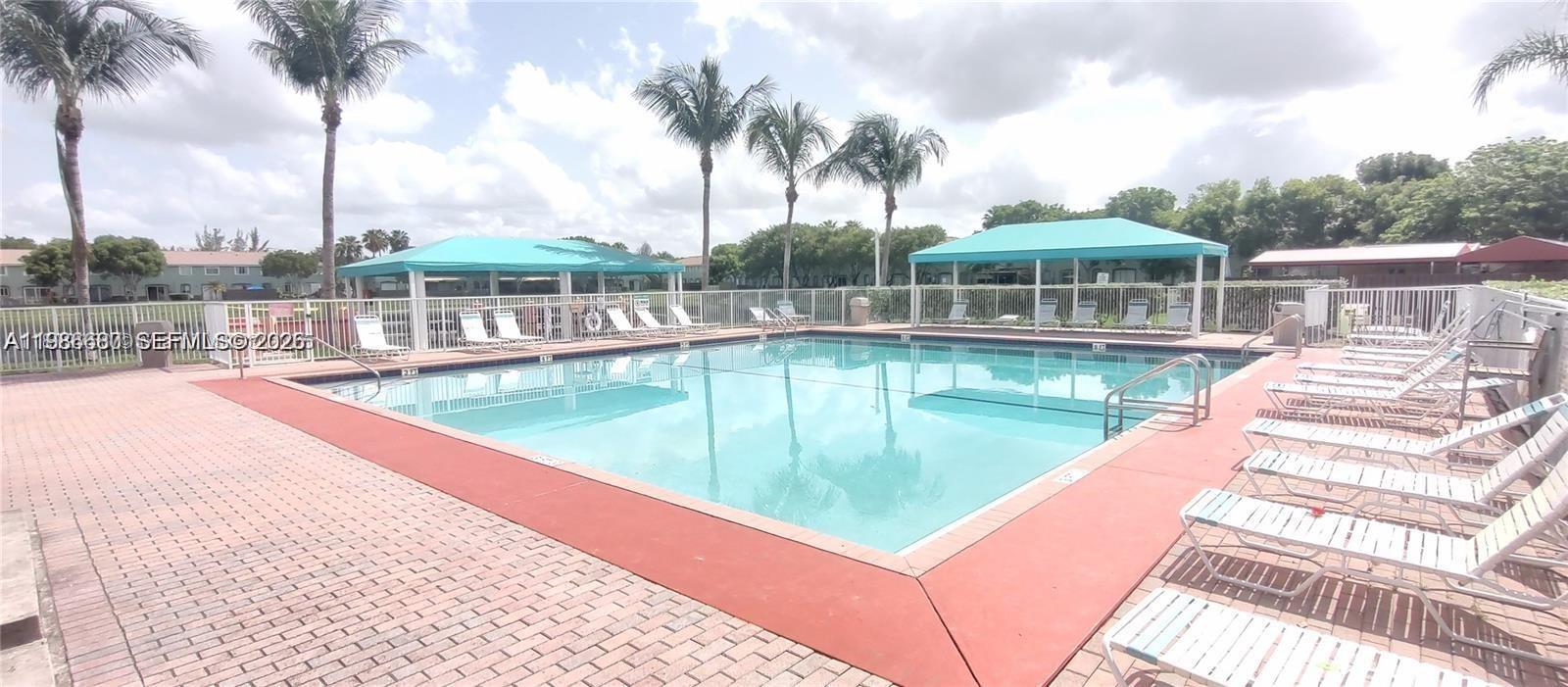 2470 Southeast 15th Place, Unit 335 Homestead, FL 33035 - Photo 31 of 33 a view of a swimming pool with a patio