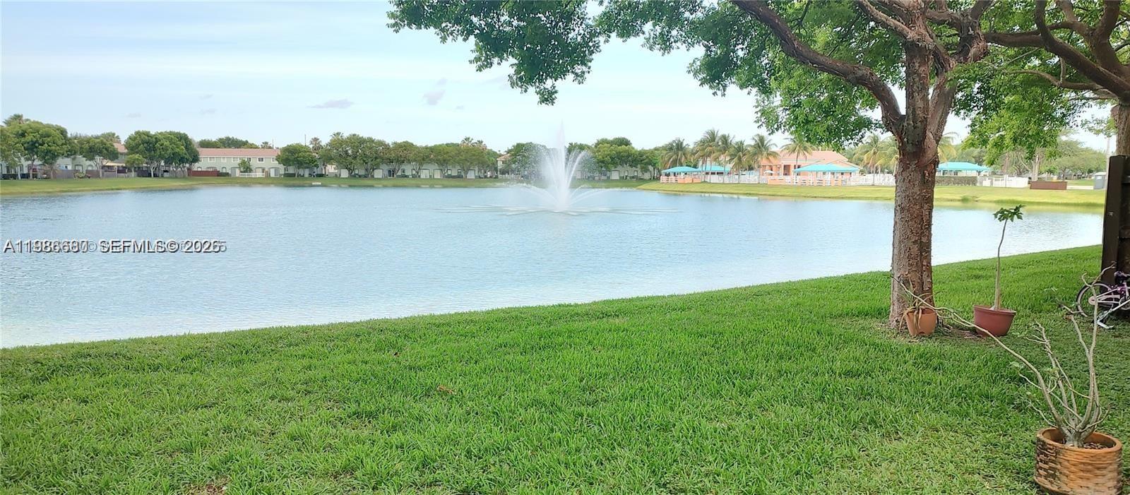 2470 Southeast 15th Place, Unit 335 Homestead, FL 33035 - Photo 32 of 33 a view of a lake with houses in the back