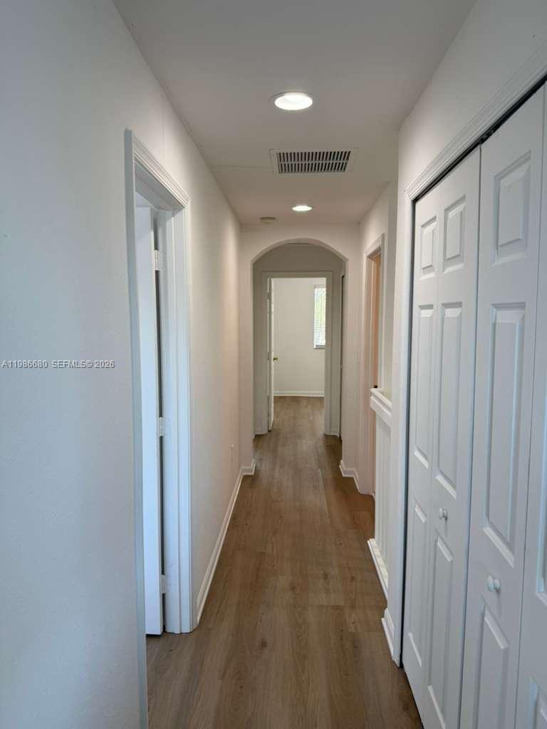 2470 Southeast 15th Place, Unit 335 Homestead, FL 33035 - Photo 5 of 33 a view of a hallway with wooden floor