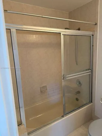 a bathroom with a glass shower door