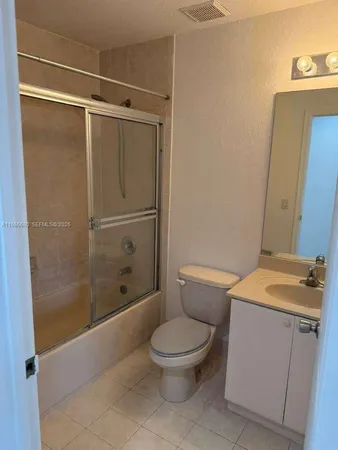 a white toilet sitting next to a bathroom sink