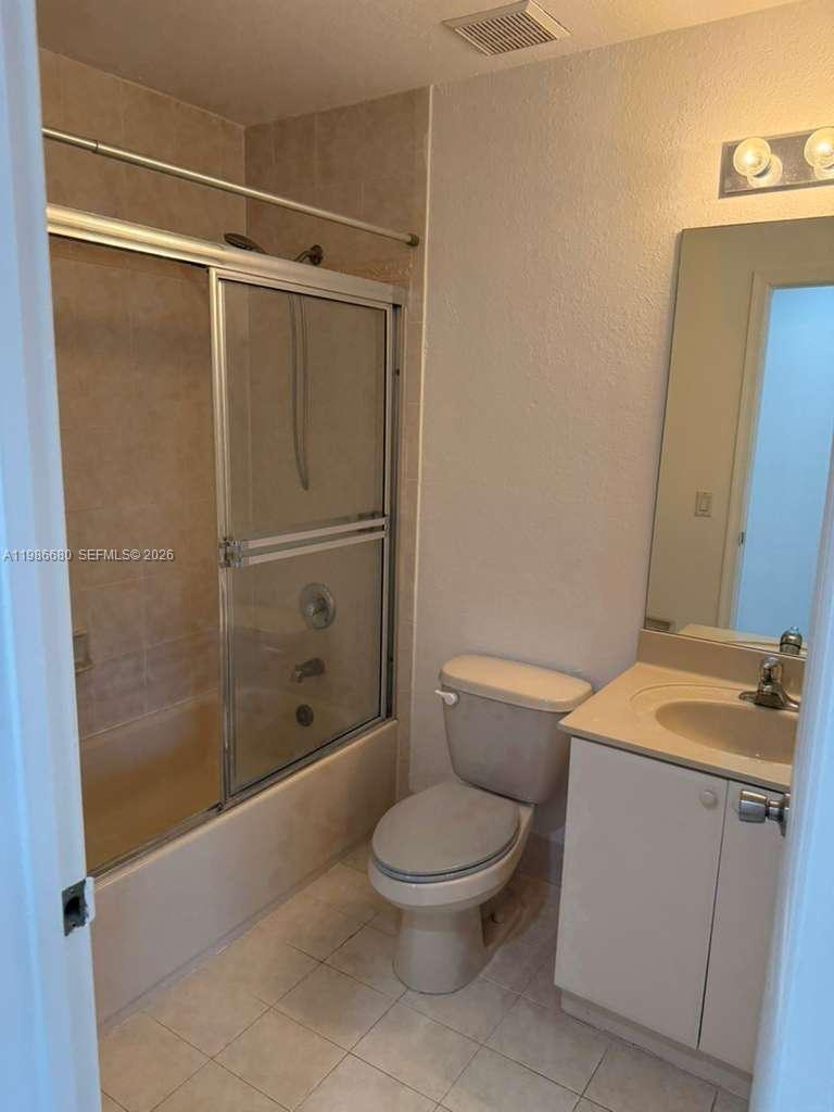 2470 Southeast 15th Place, Unit 335 Homestead, FL 33035 - Photo 10 of 33 a white toilet sitting next to a bathroom sink