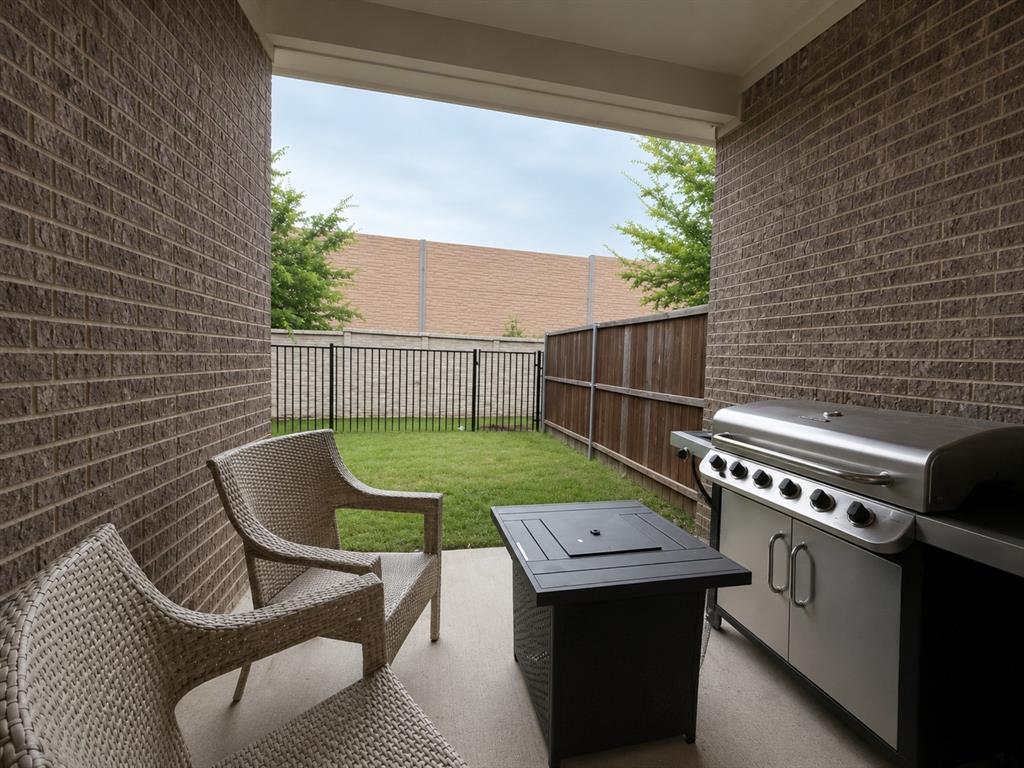 8235 Snapdragon Way Dallas, TX 75252 - Photo 22 of 29 Covered patio featuring a concrete slab and brick exterior walls