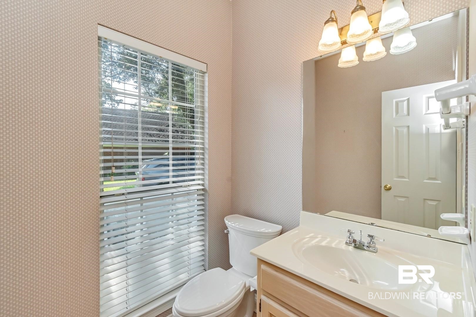 105 McHugh Lane Mobile, AL 36608 - Photo 18 of 30 Half bath with vanity and wallpapered walls