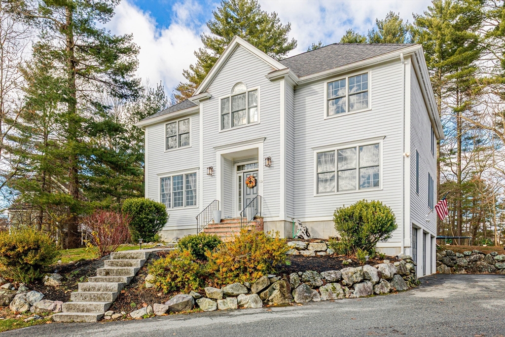 53 Emily Lane Rowley, MA 01969 - Photo 1 of 42 a front view of a house with a lots of windows and plants