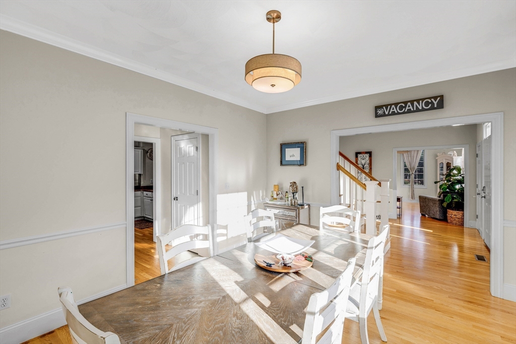 53 Emily Lane Rowley, MA 01969 - Photo 11 of 42 a living room with dining table and a wooden floor