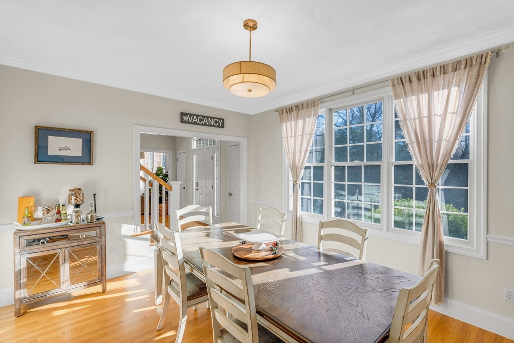 53 Emily Lane Rowley, MA 01969 - Photo 13 of 42 a view of a dining room with furniture a chandelier and wooden floor