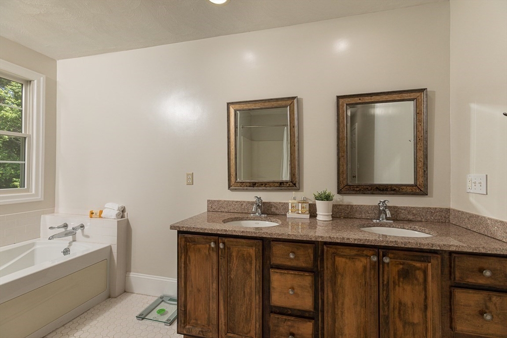 53 Emily Lane Rowley, MA 01969 - Photo 18 of 42 a bathroom with double vanity sinks and a bathtub
