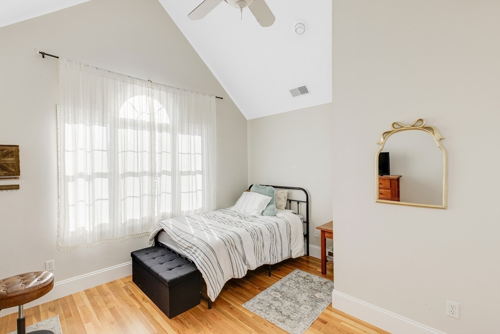 53 Emily Lane Rowley, MA 01969 - Photo 23 of 42 a bedroom with a bed lamp on table and a window