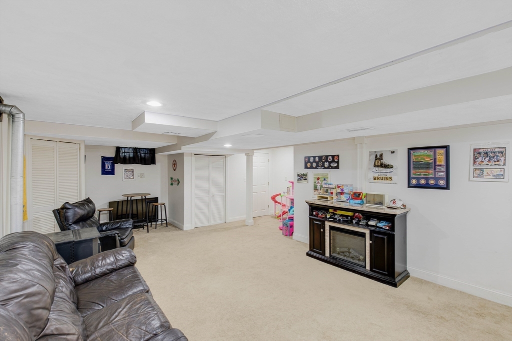 53 Emily Lane Rowley, MA 01969 - Photo 25 of 42 a bed room with furniture and a flat screen tv