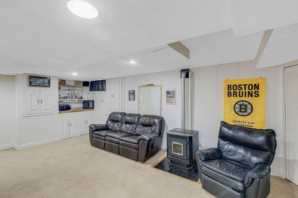 53 Emily Lane Rowley, MA 01969 - Photo 26 of 42 a living room with furniture and a refrigerator