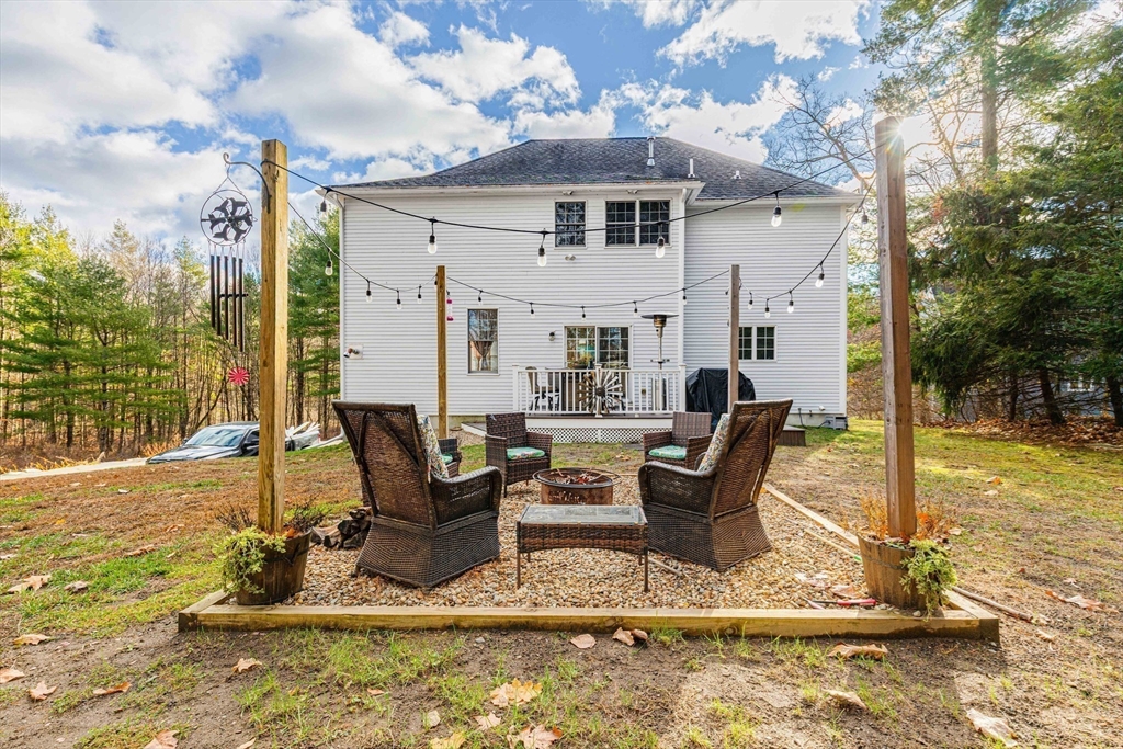 53 Emily Lane Rowley, MA 01969 - Photo 29 of 42 a view of a patio with table and chairs near a yard
