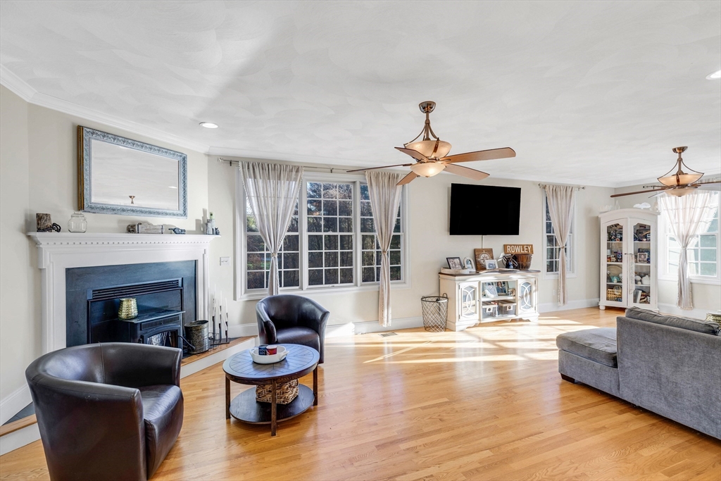 53 Emily Lane Rowley, MA 01969 - Photo 6 of 42 a living room with furniture a fireplace and a flat screen tv