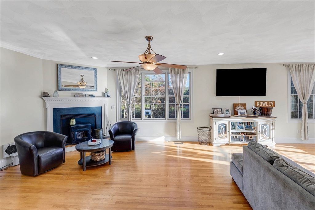 53 Emily Lane Rowley, MA 01969 - Photo 7 of 42 a living room with furniture a fireplace and a flat screen tv
