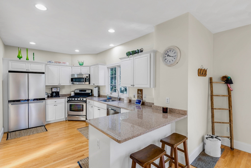 53 Emily Lane Rowley, MA 01969 - Photo 9 of 42 a kitchen with stainless steel appliances granite countertop a sink stove and refrigerator