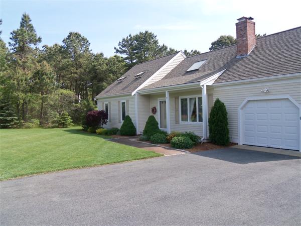 34 Monomoscoy Road Mashpee, MA 02649 - Photo 1 of 16 a front view of a house with garden