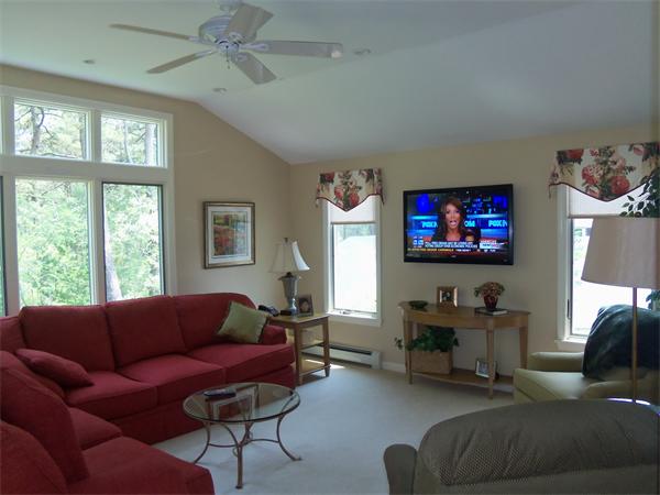 34 Monomoscoy Road Mashpee, MA 02649 - Photo 7 of 16 a living room with furniture a large window and a flat screen tv