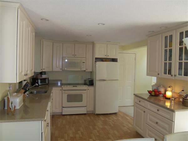 34 Monomoscoy Road Mashpee, MA 02649 - Photo 8 of 16 a kitchen with a refrigerator stove and sink