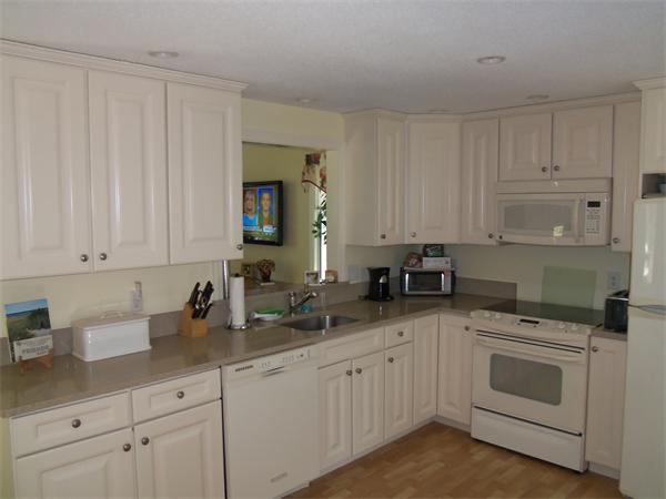34 Monomoscoy Road Mashpee, MA 02649 - Photo 9 of 16 a kitchen with white cabinets and white appliances