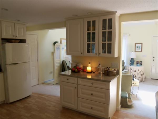 34 Monomoscoy Road Mashpee, MA 02649 - Photo 10 of 16 a kitchen with a refrigerator and cabinets