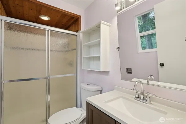 a bathroom with a sink toilet and shower