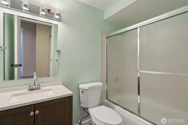 a bathroom with a toilet a sink and shower