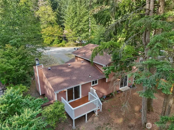 an aerial view of a house with garden space and sitting area