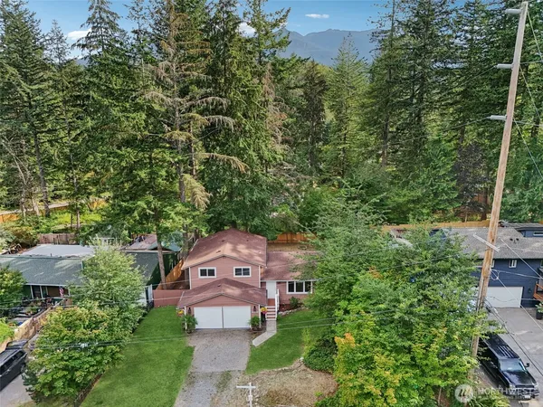 an aerial view of a house with a yard