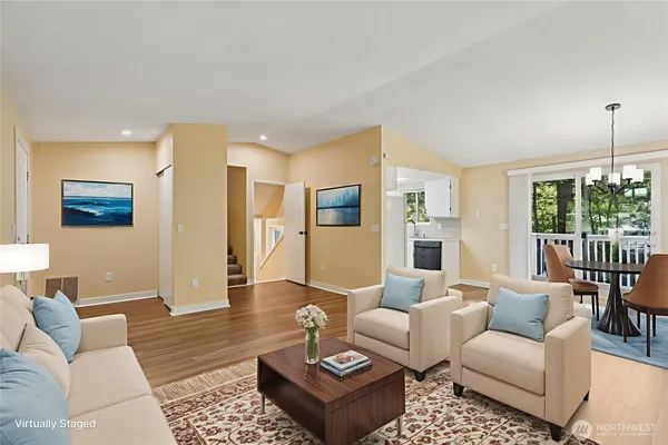 a living room with furniture and wooden floor