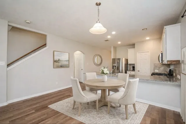 a view of a kitchen with wooden floor and a kitchen
