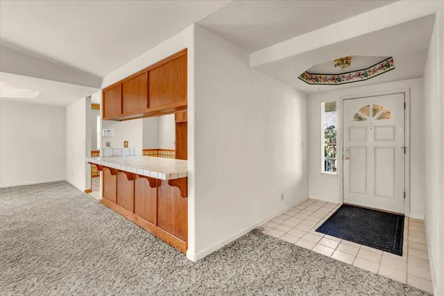 an empty room with windows and fireplace